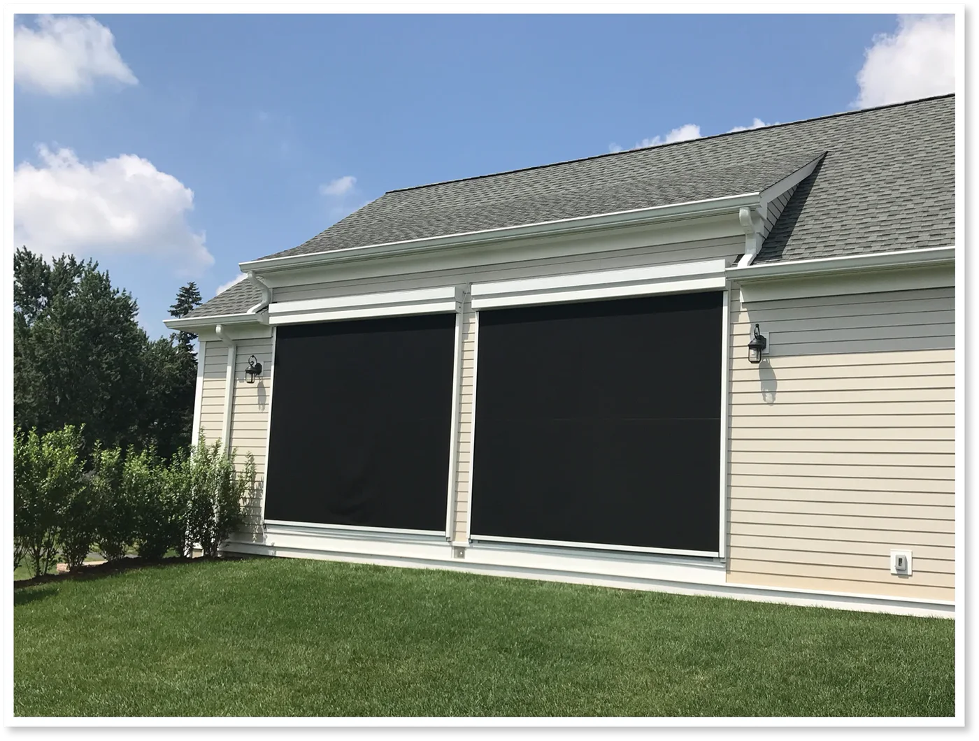 Eclipse Outdoor motorized screens deployed across exterior openings on a home