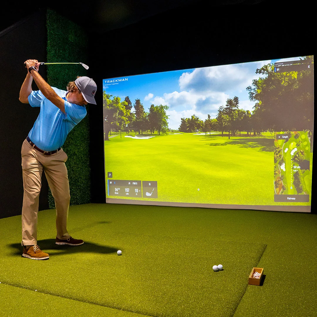 Screenshot Golf impact screen in play, golfer mid-swing in a simulator bay